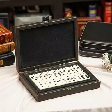 Dominoes in a wooden case with leather inserts by Manopoulos