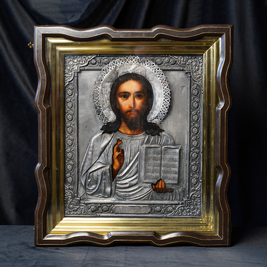 An antique icon of the Savior from the last quarter of the 19th century in a silver frame