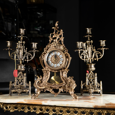 A set of bronze pendulum clock and two "Beautiful past" candelabra by Virtus