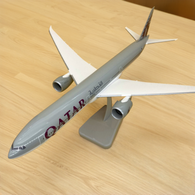 Scale model of the Boeing B777-9X Qatar aircraft made of plastic on a stand