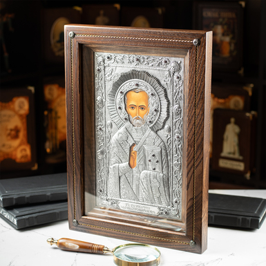 Nicholas the Wonderworker icon with silver plating in a wooden frame