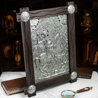 Icon of St. George the Victorious with silver plating in a wooden frame