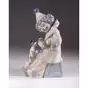 figurine of a clown with an accordion and a dog
