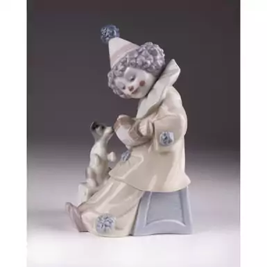 статуетка клоуна з гармошкою та собакою