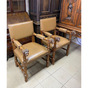 pair of leather and wood chairs