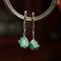 earrings with an emerald