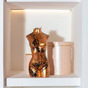 Decorative black and gold art lamp "Aphrodite" on a shelf