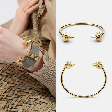 a small unisex gold-plated bracelet on the hand