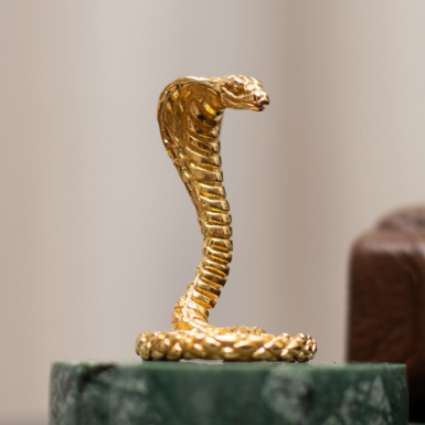 Cobra statuette on a stand photo