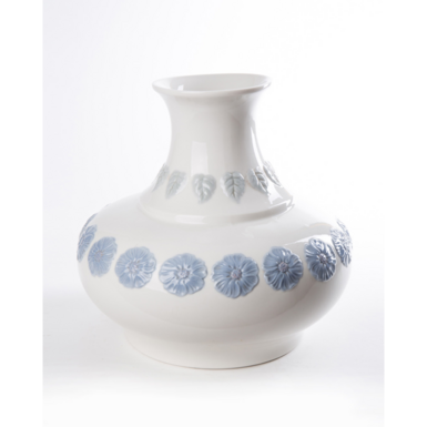 Vase with delicate blue flowers photo