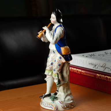 Figurine boy with a pipe photo