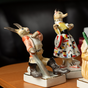 Porcelain figurines on stands photo
